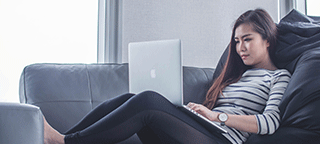 woman relaxing playing online bingo